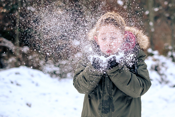 Young child playing with snow