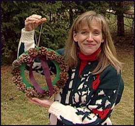 Woman holding pinecone wreath