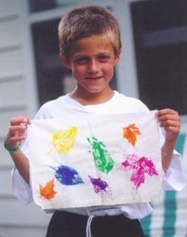 Child holding leaf print bandana