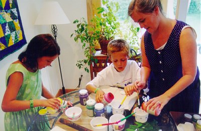 Mom and kids pouring paint