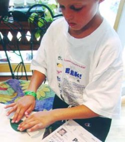 Child pressing leaf